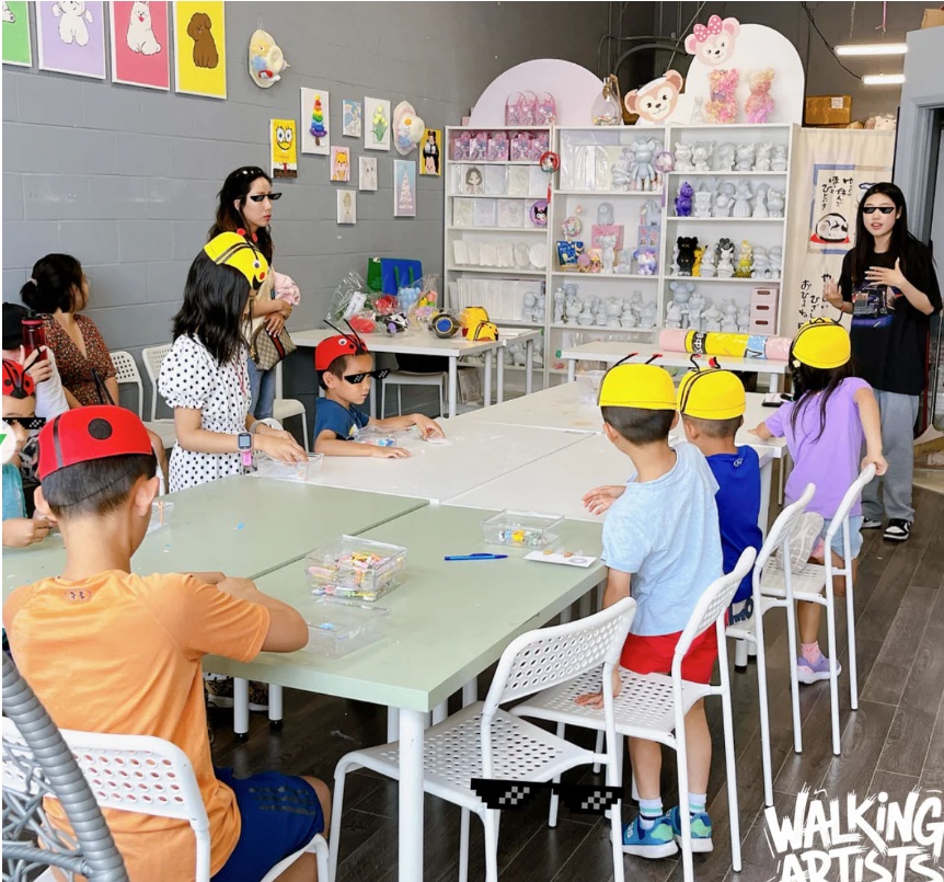 Children seated for a guided art activity